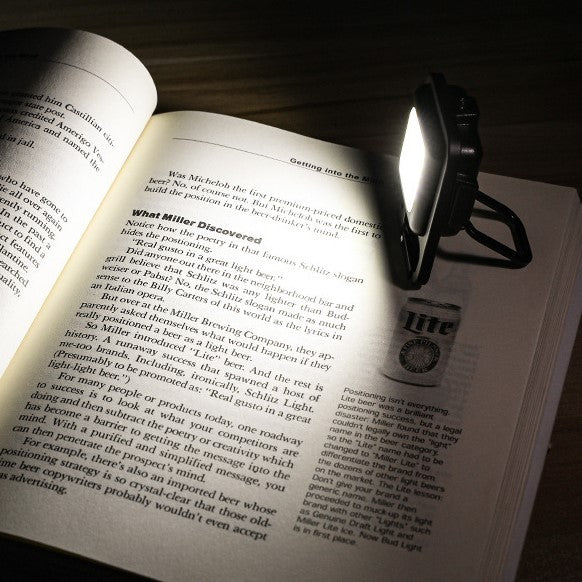 Portable Multi-Purpose Mini LED Flashlight on a book