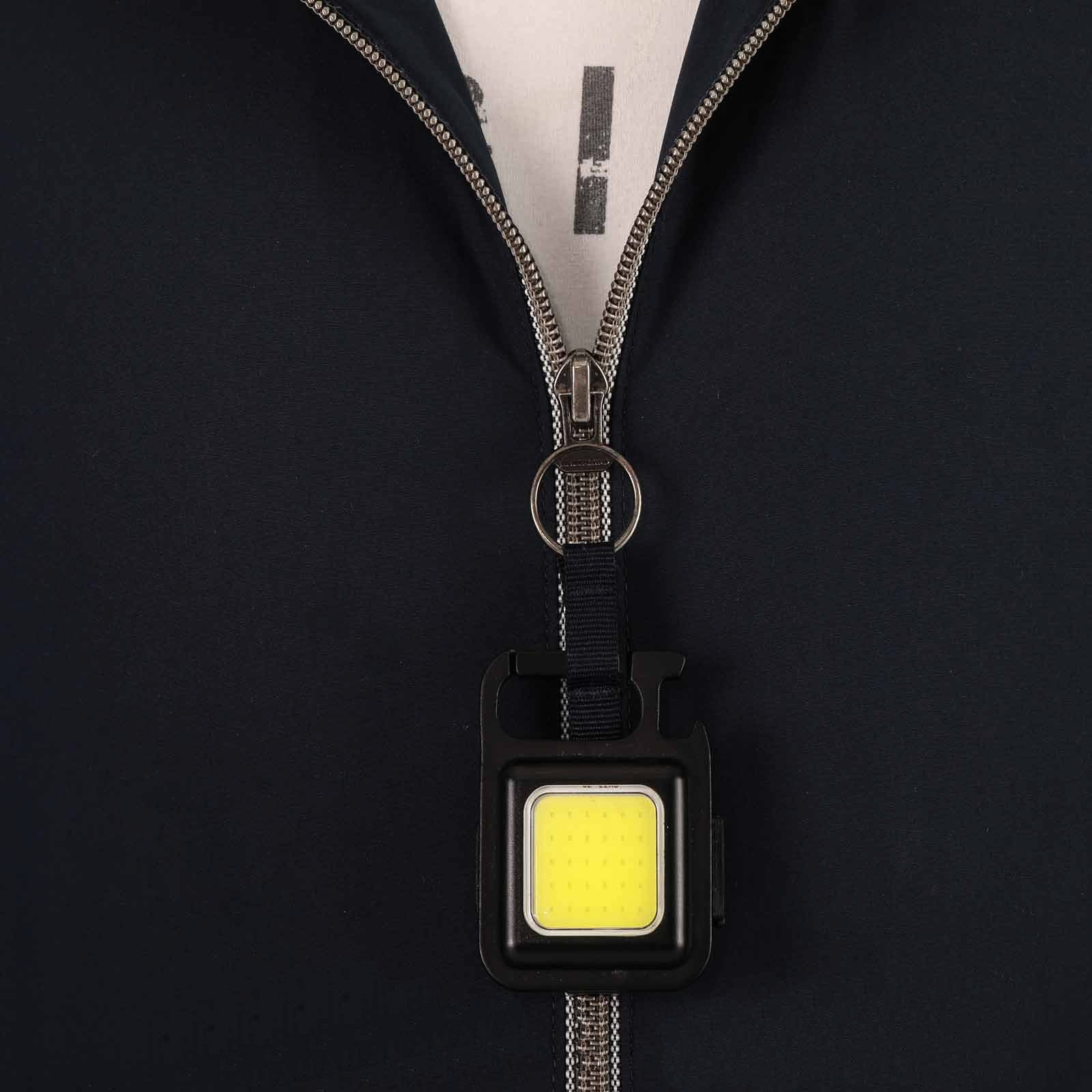 Portable Multi-Purpose Mini LED Flashlight attached to the sweatshirt