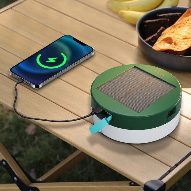 Green LED Color Solar Charger on a desk, harnesses solar power to charge a phone.